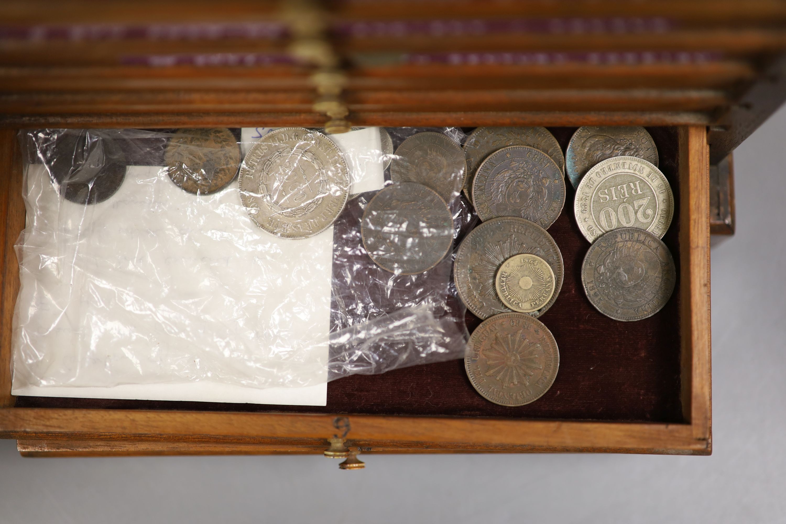 A mahogany coin collector's cabinet, fitted single door enclosing 10 drawers containing British and other coins (Georgian and later), tokens, etc.